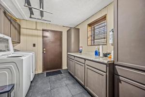 a laundry room with a washer and dryer in it at Grassy Paradise by Avada Properties in Sevierville