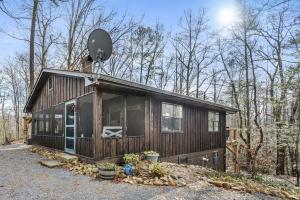 a small house with a satellite on top of it at Grassy Paradise by Avada Properties in Sevierville