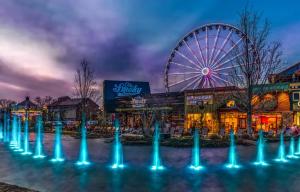 a ferris wheel in front of a amusement park at Grassy Paradise by Avada Properties in Sevierville +30 photos