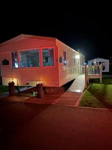 a small train car parked on the street at night at M&js caravan hire in Kinmel Bay