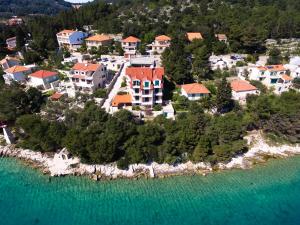 an aerial view of a house on an island in the water at Apartments Vala in Vela Luka