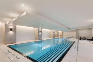 a large swimming pool in a building at Cozy Condo Near Restaurant TTC in Toronto