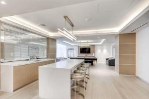 a kitchen with a large island and a living room at Cozy Condo Near Restaurant TTC in Toronto