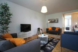 a living room with a couch and a tv at Spacious Apartment for 6 in Espoo