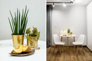 Un comedor con una mesa y un plato de fruta. en Nowy Świat Suite, en Wroclaw 2 fotos más