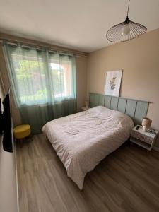 a bedroom with a bed and a window at Mini studio privatif in Privas