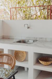a white counter with a sink and two baskets at Nikolaidis Villa Family Friendly in Nea Kallikrateia +36 photos