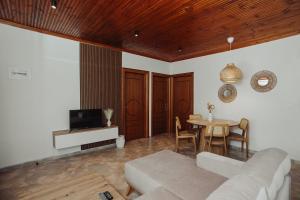 a living room with a couch and a table at Nikolaidis Villa Family Friendly in Nea Kallikrateia
