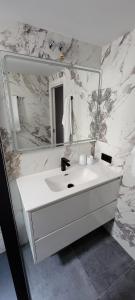 a white bathroom with a sink and a mirror at Sol Del Mar in Benicarló +35 photos