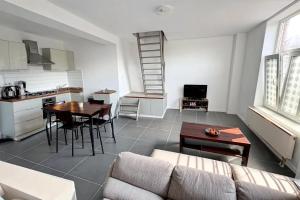 a living room with a couch and a table at Résidence Rachel Appartment B in Braine-le-Comte