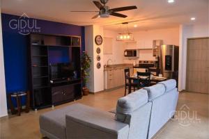 a living room with a couch and a table and a kitchen at The Downtown Apartment - 3 A/C bedroom + WiFi in San Salvador