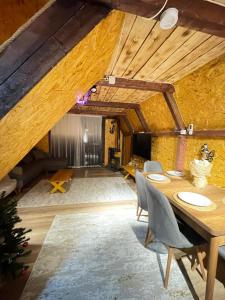 a dining room with a wooden table and chairs at Riverside house in Akcaabat