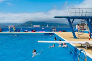 a group of people in the swimming pool on a cruise ship at THE RESTING LION - Gourock Town Center Holiday Home Apartment in Gourock