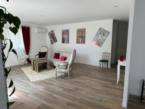 a living room with a couch and a table and chairs at La Maison Belle Étoile in Limoux +2 photos