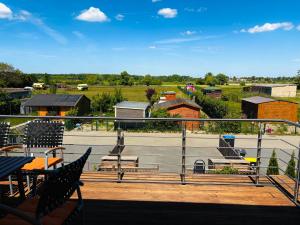 a balcony with chairs and a view of a park at Wohlfühl Oase mit Sauna vor den Toren Berlins in Nauen +50 photos