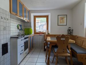 a kitchen with a table and a dining room at Casa Letizia in Breil/Brigels