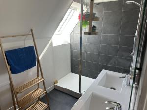 a small bathroom with a sink and a shower at Maison spacieuse et lumineuse à seulement 1 minute de la mer in Rosnoën +36 photos