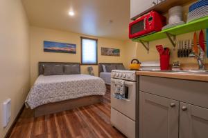 a small bedroom with a bed and a kitchen at Emigrant Cabins Tiny cabin near Yellowstone in Emigrant