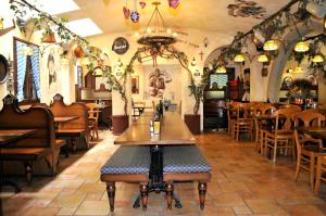 a restaurant with tables and chairs in a room at Hotel Vittoria in Riva del Garda