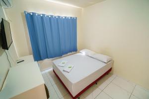 Ein Bett oder Betten in einem Zimmer der Unterkunft Hotel Janaína