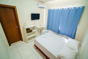 Ein Bett oder Betten in einem Zimmer der Unterkunft Hotel Janaína
