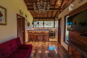 a living room with a bar in a house at Chalé da Montanha in Domingos Martins