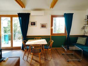 a living room with a table and chairs at Surányi kék házak in Pócsmegyer