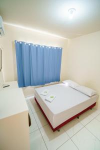 Ein Bett oder Betten in einem Zimmer der Unterkunft Hotel Janaína