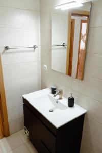 un baño con lavabo y espejo en StayinSetubal, en Setúbal