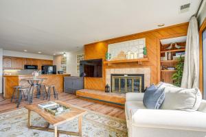 a living room with a couch and a fireplace at Pool Access: Scenic Condo in Wintergreen Resort! in Mount Torry Furnace