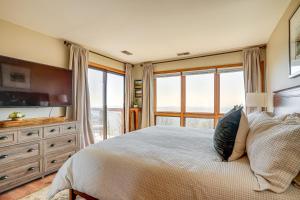 a bedroom with a large bed and a large window at Pool Access: Scenic Condo in Wintergreen Resort! in Mount Torry Furnace +19 photos