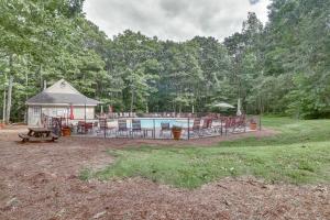 a backyard with a pool and a pavilion with tables and chairs at Pool Access: Scenic Condo in Wintergreen Resort! in Mount Torry Furnace