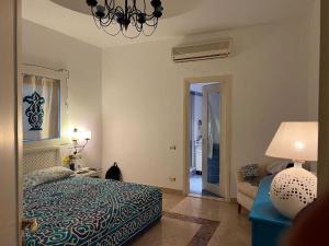 a bedroom with a bed and a couch and a lamp at Domina Coral Bay Resort in Sharm El Sheikh