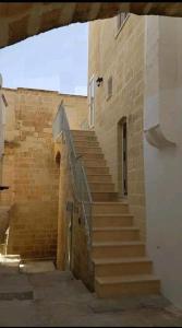 a set of stairs in a brick building at Gravina House in Castellaneta
