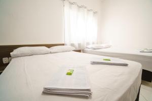 Ein Bett oder Betten in einem Zimmer der Unterkunft Hotel Janaína