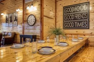 a long wooden table in a room with a clock on the wall at Eat, Drink and Be Beary by Avada Properties in Sevierville