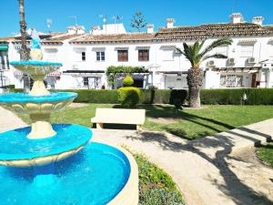 a blue fountain in front of a building at Bungaló junto a la piscina #PRP008 StayOrihuela in Torrevieja