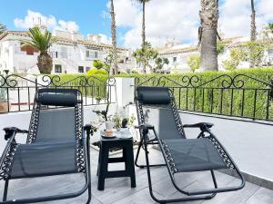 two chairs and a table on a balcony at Bungaló junto a la piscina #PRP008 StayOrihuela in Torrevieja