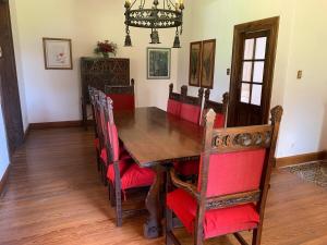 a dining room with a wooden table and chairs at Villa María, nature and relaxation in Gualeguay +3 photos