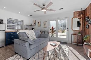 a living room with a couch and a table at Private Garden Retreat | King Bed | TMH + Downtown in Perkins