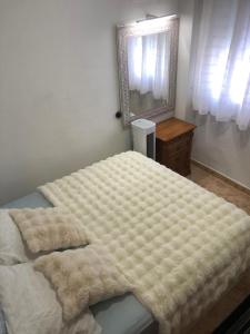a bedroom with a large bed and a mirror at Habitación Privada en Piso Compartido - NR 2 in Torrevieja +5 photos