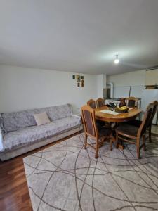 a living room with a table and a couch at Domaćinstvo Ristović in Banovo Polje