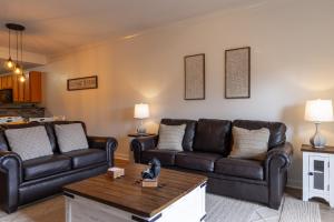 a living room with leather couches and a coffee table at Cozy Vista Condo by Avada Properties in Pigeon Forge