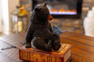 a figurine of a bear holding a fish on a table at Cozy Vista Condo by Avada Properties in Pigeon Forge