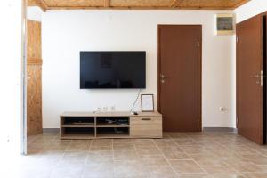 a living room with a television on a wall at Green Harmony in Tivat