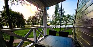 a porch with a wooden table and two chairs at Marina Złotowo in Złotowo