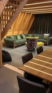 a conference room with a table and green couches at Vikendica Sofijina Luka in Slatina Varoš +30 photos