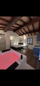 a large living room with a red table in it at Casale Antica Cassia Luxury & Spa in Rome