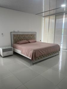 a bed in a white room with a large bed sidx sidx sidx at Finca Hotel Villa el Ocaso Huila in Rivera +196 photos