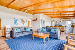 a living room with two couches and a table at Sands of Time in Lincoln City